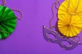 Festive Mardi Gras masquerade purple background. Fat Tuesday carnival, masks, beads, traditional decor Royalty Free Stock Photo