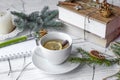 A festive mock up photo with a fir twigs, an opened note book, an old book, a pencil, cones, a candle and decation elements