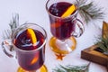 Festive mulled wine on the snow. Holiday decorations, cones, pine twigs.