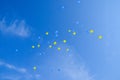 Festive multi-colored balloons in the blue sky Royalty Free Stock Photo