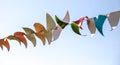 Festive multi-colored flags on a background of blue sky Royalty Free Stock Photo