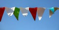 Festive multi-colored flags on a background of blue sky Royalty Free Stock Photo