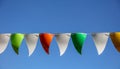 Festive multi-colored flags on a background of blue sky Royalty Free Stock Photo