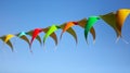 Festive multi-colored flags on a background of blue sky Royalty Free Stock Photo