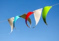 Festive multi-colored flags on a background of blue sky Royalty Free Stock Photo