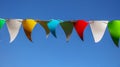 Festive multi-colored flags on a background of blue sky Royalty Free Stock Photo