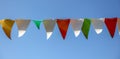 Festive multi-colored flags on a background of blue sky Royalty Free Stock Photo