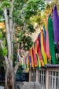 Festive multi-colored satin ribbons decorate the street. Bright ribbons hang in a row in the park. Selective focus