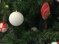 Festive multicolored beautiful shiny fancy balls, toys, gift boxes, decorations on the Christmas green tree with needles