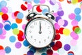 Confetti in the form of circles and silver retro alarm clock isolated on white background Royalty Free Stock Photo