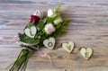 Festive multicolored roses and hearts on wooden table Royalty Free Stock Photo