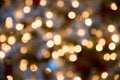 Festive New-year background with bokeh from Christmas tree lights glowing. Blurred colorful circles on light holiday Royalty Free Stock Photo