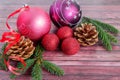 Festive New Year`s composition for congratulations with bright balls and green pine branches with cones. Royalty Free Stock Photo