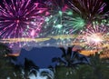 Festive New Years fireworks over the sea and mountains on tropical island Royalty Free Stock Photo