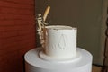 Festive one tiered birthday white cake in rustic style, decorated dry wheat spikelets and vanilla cream icing on stand Royalty Free Stock Photo