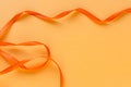 Festive orange ribbon waves on orange background