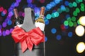 Festive package with bottles of wine against blurred lights. Bokeh effect