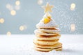 Festive pancake christmas tree with powdered sugar and holiday decorations Royalty Free Stock Photo