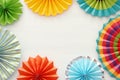 Festive and party background with colorful paper circle fans over wooden white background. Copy space. Royalty Free Stock Photo