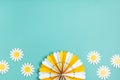 Festive party background with yellow paper circle fans over blue pastel background