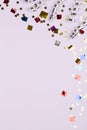 Festive party border or frame of silver spiral streamers and confetti on pink background Royalty Free Stock Photo