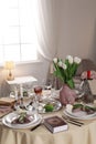 Festive Passover table setting with Torah at home. Royalty Free Stock Photo