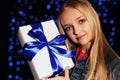 Festive photo of cute little girl whith long blond hair holding a gift-box Royalty Free Stock Photo