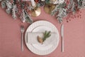 Festive place setting with beautiful dishware, cutlery and cone for Christmas dinner on pink tablecloth, flat lay Royalty Free Stock Photo