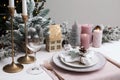 Festive place setting with beautiful dishware, cutlery and cone for Christmas dinner on white wooden table Royalty Free Stock Photo