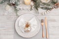 Festive place setting with beautiful dishware, cutlery and decor for Christmas dinner on white wooden table, flat lay Royalty Free Stock Photo