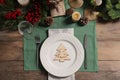 Festive place setting with beautiful dishware, cutlery and decor for Christmas dinner on wooden table, flat lay Royalty Free Stock Photo