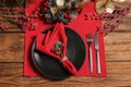 Festive place setting with beautiful dishware, cutlery and decor for Christmas dinner on wooden table, flat lay Royalty Free Stock Photo