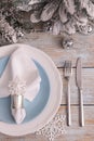 Festive place setting with beautiful dishware, cutlery and fabric napkin for Christmas dinner on light blue wooden table, flat lay Royalty Free Stock Photo