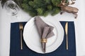 Festive place setting with beautiful dishware, cutlery and fabric napkin for Christmas dinner on white table, flat lay Royalty Free Stock Photo