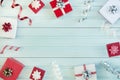 Festive postcard. Gifts in beautiful red and white boxes lie on a light blue background.