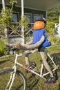 A festive pumpkin rides a bicycle along Crawford Notch, New Hampshire