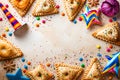 Festive Purim background, Purim attributes, triangular pies, Haman ears, traditional hamantaschen cookies. Postcard on a