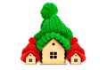 Festive Real Estate Trio: Houses in Christmas-Hued Knit Hats Royalty Free Stock Photo