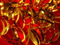 Festive red background.Golden shimmerring shiny ribbons texture glowing decorations backdrop.Holidays New year Christmas Royalty Free Stock Photo