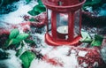 Festive red candle in lantern and mug of coffee on rug with snow Royalty Free Stock Photo