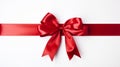 Festive red ribbon bow on long straight ribbon, isolated on white background with text space Royalty Free Stock Photo