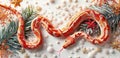 Festive red and white patterned snake with Christmas decorations on a light background. Royalty Free Stock Photo