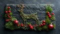 Festive Reindeer Decor with Fir Branches & Red Bauble on Black Stone - Christmas Concept Royalty Free Stock Photo