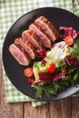 Festive roast duck breast and fresh mix green salad close-up. vertical top view Royalty Free Stock Photo