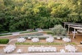 Festive round tables stand on a wooden deck near the main long table in the garden