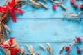 Festive rustic blue background with wheat, red bows, and gift Royalty Free Stock Photo