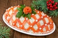 Festive salad, decorated with salmon on a wooden table