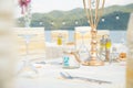 Festive serving table on the beach in sunny day. Preparing for an open-air party in the beach Royalty Free Stock Photo