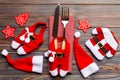 Festive set of fork and knife on wooden background. Top view of new year decorations and santa clothes and hat. Close up of Royalty Free Stock Photo