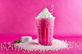 Festive setting with a vibrant pink bubble tea crowned with whipped cream and tapioca pearls. Royalty Free Stock Photo